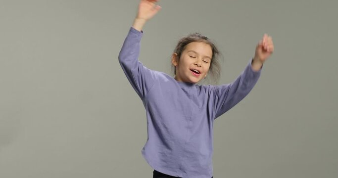 Emotional little girl with stress despair isolated on grey background. Adhd attention deficit hyperactivity disorder. Child negative emotion