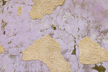 Aged purple wall texture with peeling paint. Distressed and cracked purple paint texture.