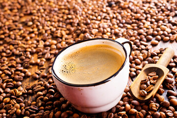 Coffee in cup on wooden table in cafe