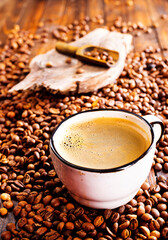 Coffee in cup on wooden table in cafe