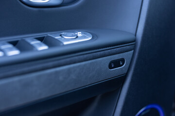 Control buttons for settings and memory of the driver's seat, electric glass opening, door handle in the interior of the new luxury electric car. Driver's seat adjustment buttons