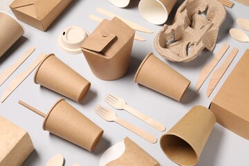 Eco friendly food packaging. Paper containers and tableware on light grey background