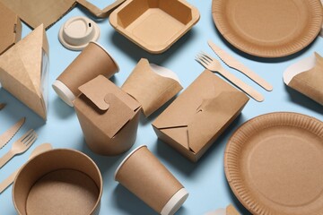 Eco friendly food packaging. Paper containers and tableware on light blue background - obrazy, fototapety, plakaty