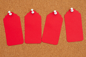 Corkboard with 4 red gift tags and pushpin - 786607668