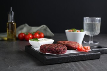 Tasty fried vegetarian cutlets served on grey table