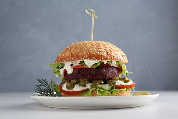 Vegetarian burger with delicious patty on white table