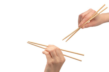 Female hand holding wooden sushi chopsticks isolated on white background.