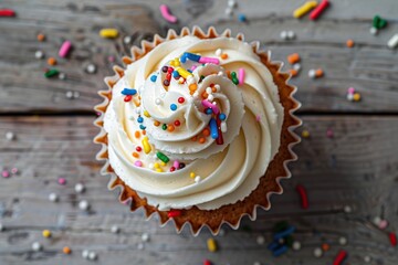 Flat lay of tasty cupcake with butter cream and sprinkles on wooden table - obrazy, fototapety, plakaty