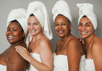 Beautiful multiracial women smiling on camera during spa day - Multi generational people doing skin...