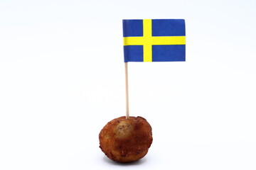 Swedish meatball concept. Flag of Sweden. Close up with white background.