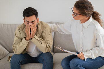 Upset man with hand on face during therapy