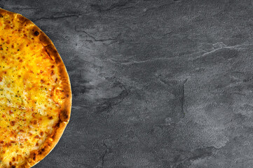 Part of cheese pizza on a gray concrete background. Top view, space for text