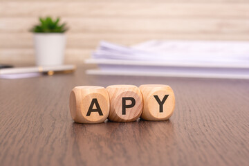 letters APY written on wooden cubes. Annual Percentage Yield concept