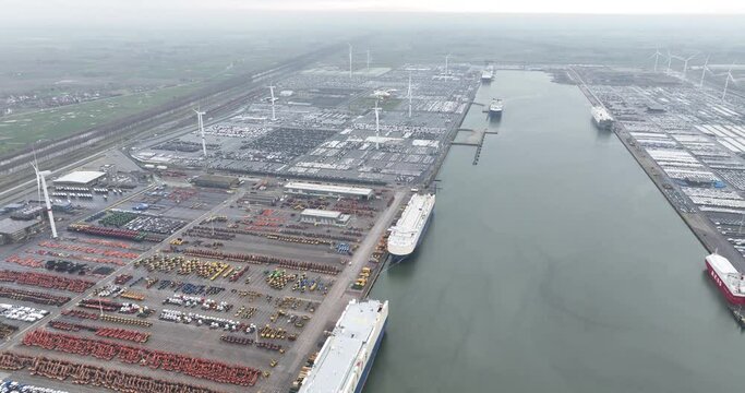 Roll on roll off terminal Zeebrugge, part of the Antwerp Brugges port. Transportation of vehicles by ship over seas. Aerial drone view.