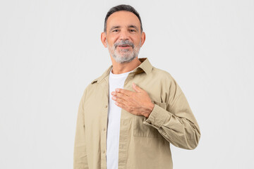 Elderly man with hand on heart gesture