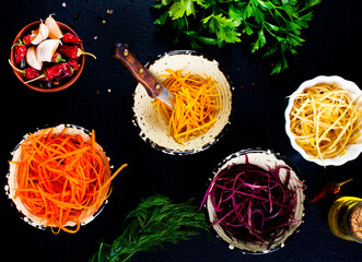 grated color carrot in bowls, raw carrot