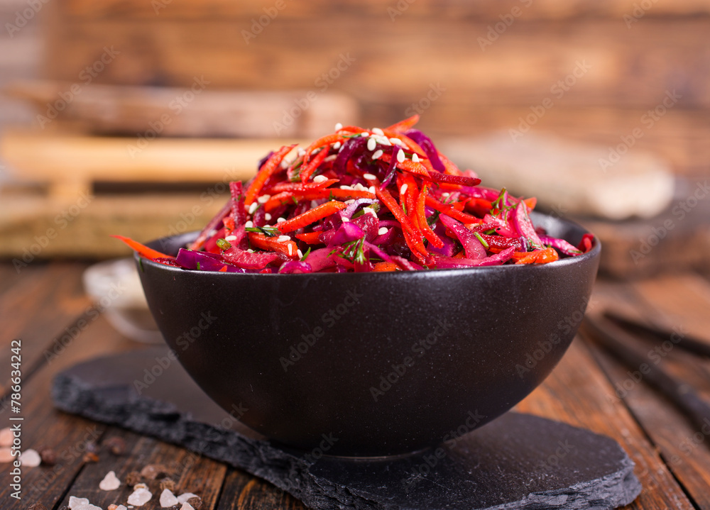 Poster fresh vegetable salad with sauerkraut cabbage, grated carrots and beetroots