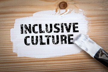 Inclusive Culture. White paint and paint brush on wood texture background - 786635677