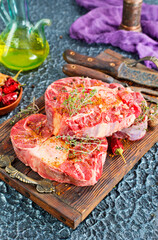 Top view of raw meat pieces placed on wooden tray sprinkled with salt - 786636233