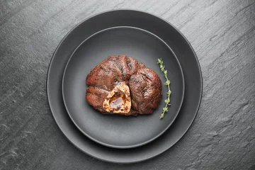 Fotobehang Tasty grilled beef meat and thyme on black table, top view © New Africa