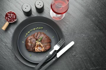 Poster Tasty grilled beef meat served on black table, flat lay. Space for text © New Africa
