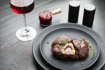 Rolgordijnen Tasty grilled beef meat served on black table © New Africa