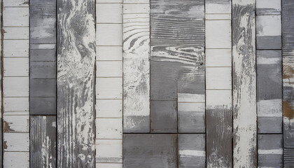 close up of a wall made of wood planks with a pattern of white and gray paint on it.