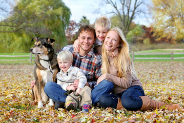 Happy Family and Pet Dog Autumn Portrait