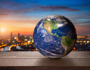 The Earth is on the table, with a blue sky and sunset in the background The globe has an elegant dark color tone, with blurred city lights at its edge