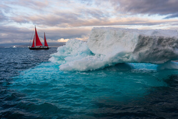 Iceberg with Red sailboat in Ilulissat Greenland - obrazy, fototapety, plakaty