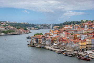 Waterfront of Douro River in Porto city, Portugal. Arrabida Bridge on background