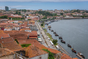 Douro River bank in Vila Nova de Gaia city, Portugal. View with traditional Rabelo boats and wine caves - obrazy, fototapety, plakaty