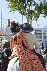 A romantic couple kissing in the world famous April fair in Seville,  Spain 
