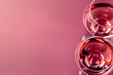 Fotobehang Rose wine glasses, selective focus, pink background, copy space. commercial banner. Abstract view of ros? wine glasses, purple background, free space. Creative top view shot of wine glasses © Alina