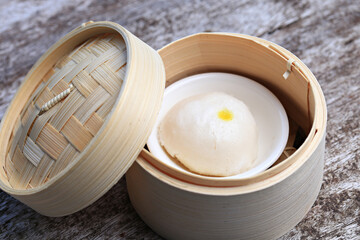 Steamed buns placed in a bamboo basket before being heated with steam 