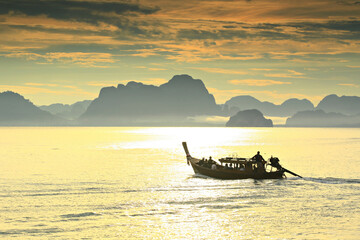 Silhouette of Traditional Thai Long tail boat (Rua hang yao) on Koh Yao Noi beach in Phang Nga...