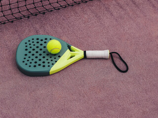 Paddle Tennis Racket and Ball on Clay Court