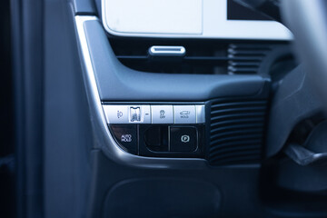 Auto hold button in a modern vehicle. ESP electronic stability program control. Interior detail of a modern electric car. ESP button. Car light switch. Dimming light button - obrazy, fototapety, plakaty