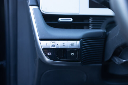 Auto hold button in a modern vehicle. ESP electronic stability program control. Interior detail of a modern electric car. ESP button. Car light switch. Dimming light button