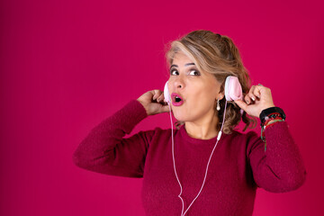 A woman wearing headphones and a red shirt