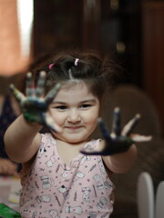 Girls playing with painting with their hands