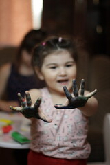 Girls playing with painting with their hands