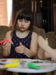 Girls playing with painting with their hands
