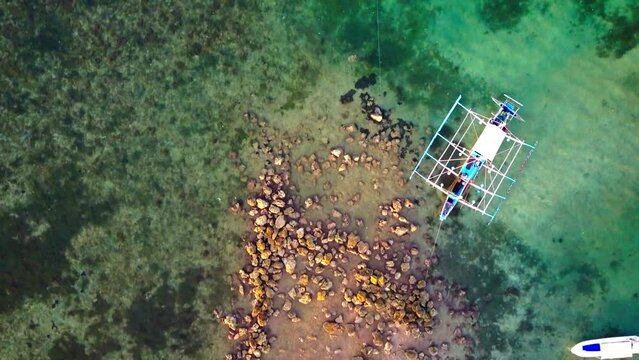 Aerial Top Backward Beautiful Shot Of Outriggers In Turquoise Sea - Puerto Princesa, Philippines