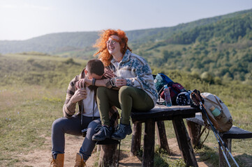 A beautiful and cheerful couple of hikers taking a break 