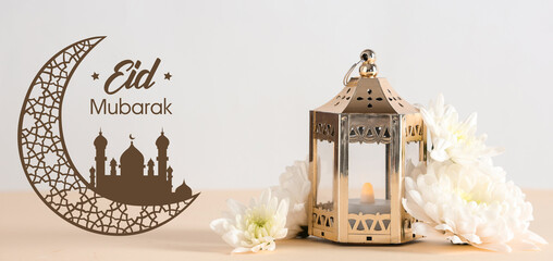 Muslim lamp with flowers on beige table against white background. Ramadan celebration