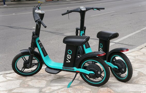 San Antonio, Texas, U.S - April 6, 2024 - The black and green Veo scooters available for short term rentals in the city