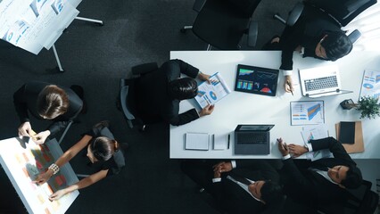 Top down view of professional business team working together to share idea while using colorful sticky note at whiteboard. Diverse project manager choosing or planning marketing strategy. Directorate.