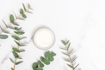 Eucalyptus inspired cosmetic cream on marble background