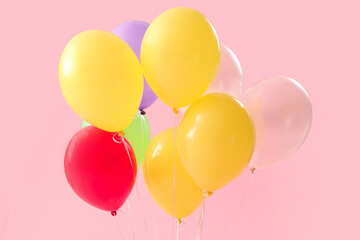 Colorful balloons on pink background